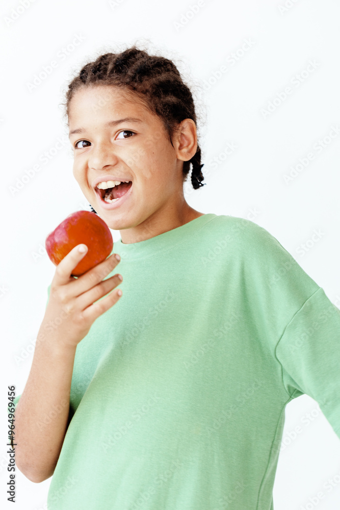 playful young boy biting into a fresh apple against a clean white background playful young boy biting into a fresh apple against a clean white background