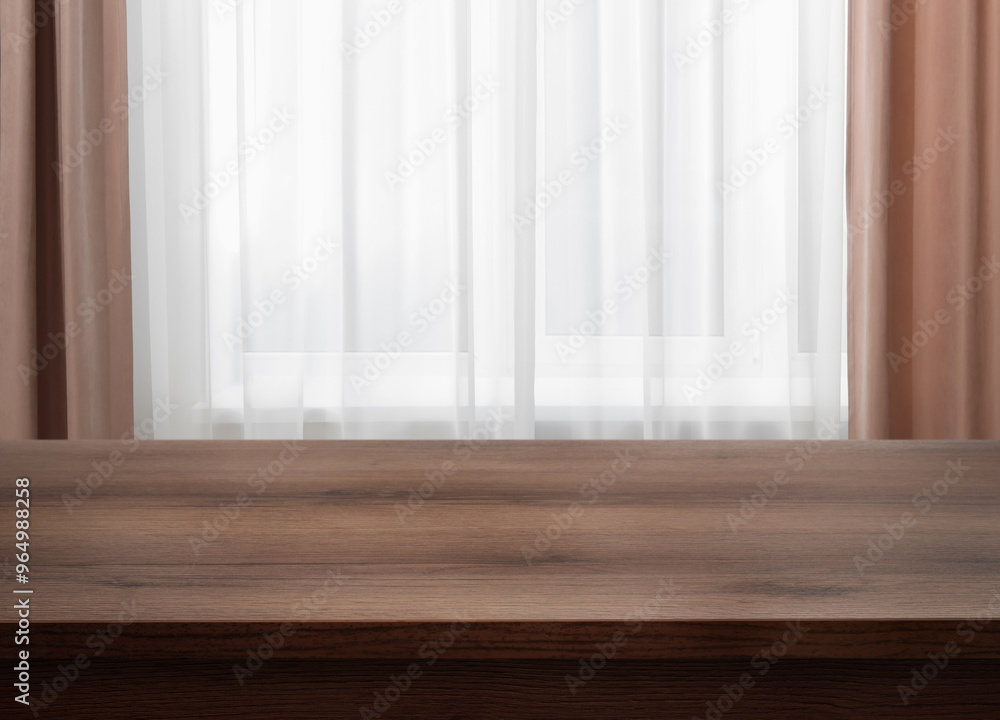 Fototapeta premium Empty wooden table near window with curtains. Space for design