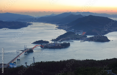 Aerial and sunset view of Samcheonpo Bridge and Choyang Bridge with cable cars connecting Neukdo Island near Sacheon-si, South Korea  photo