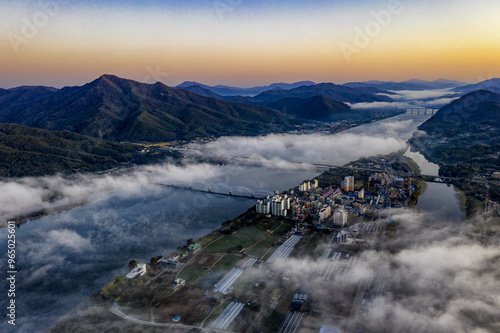 Dumulmeori, Yangpyeong-gun, Gyeonggi-do, South Korea - October 19, 2019: Aerial and sunrise view of sea of clouds and highrise apartments near Bukhan River photo