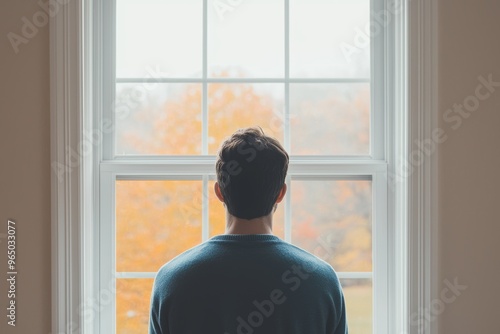 Contemplating Dysthymia: Portrait of a Person Staring Out of Window with Melancholic Gaze, Symbolizing Chronic Depression photo