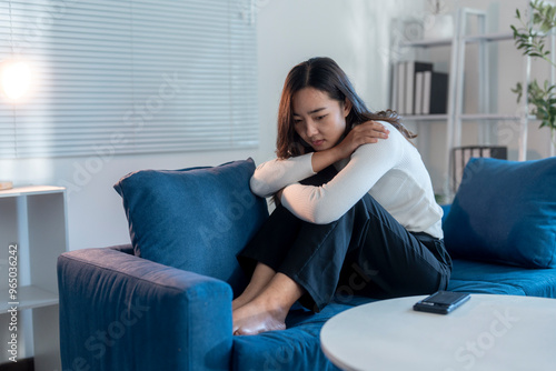 Obraz na plátně Young businesswoman feeling sad and depressed while sitting on sofa at home