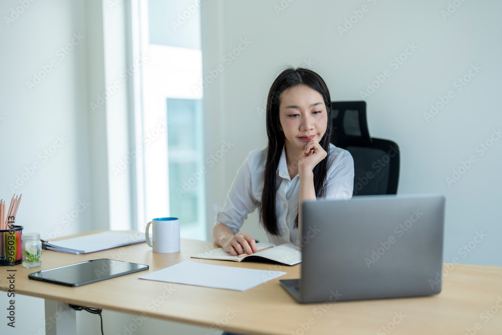 Young asian businesswoman working from home office using laptop computer Young asian businesswoman working from home office using laptop computer