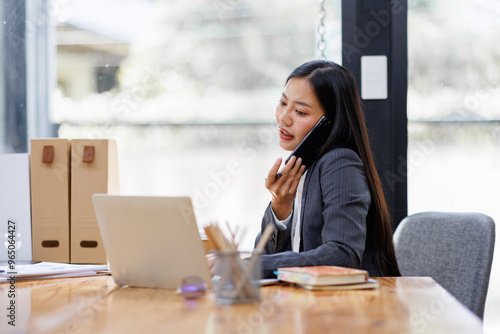 Modern Asian business woman in workplace office, doing planning analyzing the financial report, business plan investment, finance analysis concept
