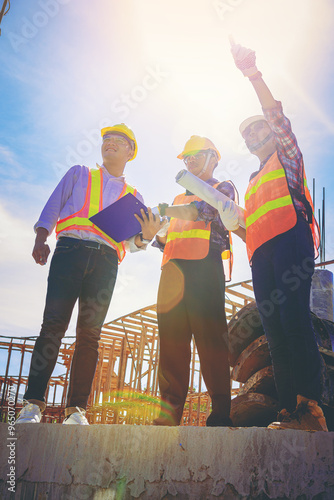 Structural engineer and architect and foreman worker with blueprints discuss, plan working for the outdoors building construction site. Construction collaboration concept photo