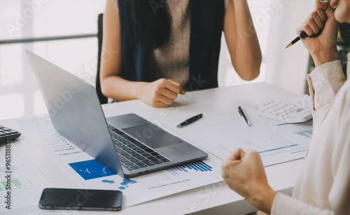 Financial analysts analyze business financial reports on a digital tablet planning investment project during a discussion at a meeting of corporate showing the results of their successful teamwork. photo