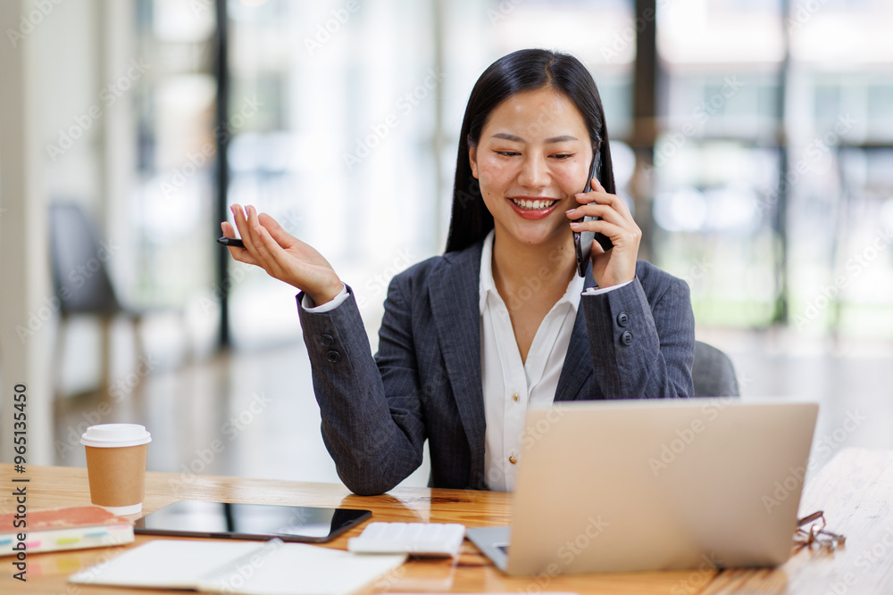 Business Asian woman freelancer is working her job on a laptop computer and phone call in the office. Doing accounting analysis report real estate investment data, Financial and tax systems concept. Business Asian woman freelancer is working her job on a laptop computer and phone call in the office. Doing accounting analysis report real estate investment data, Financial and tax systems concept.