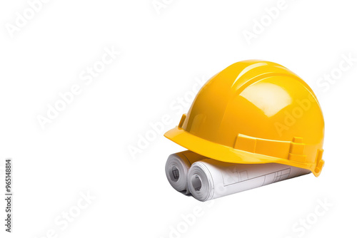 A yellow construction helmet rests on rolled blueprint plans, symbolizing safety and planning in architecture and construction.