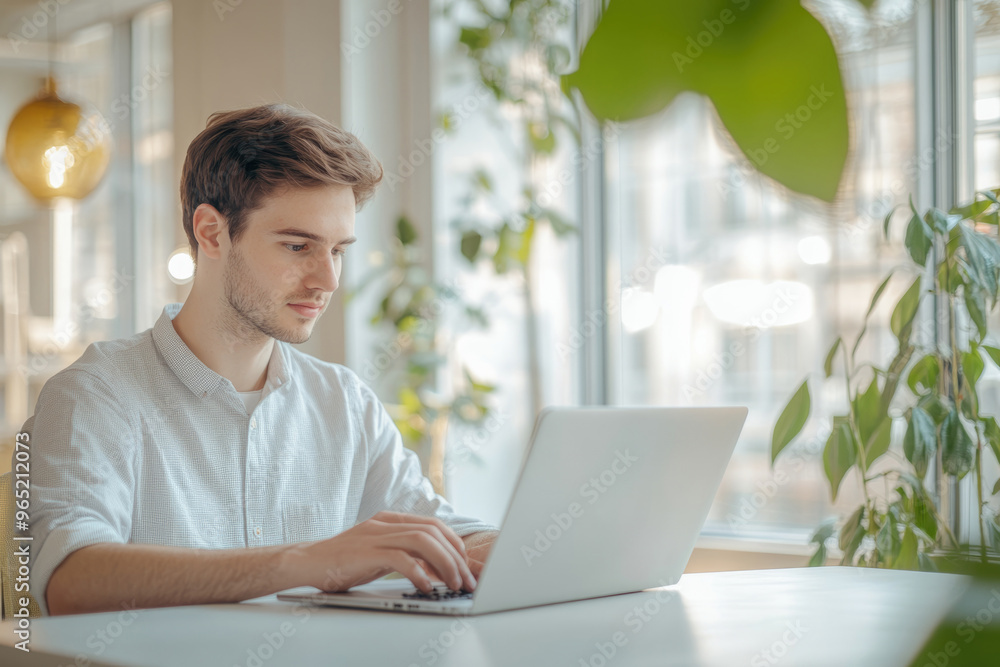High-resolution brightly lit photorealistic candid photograph of a young marketer focused on his laptop in a bright, minimalist office with a cheerful ambiance. The photograph is styled like a High-resolution brightly lit photorealistic candid photograph of a young marketer focused on his laptop in a bright, minimalist office with a cheerful ambiance. The photograph is styled like a
