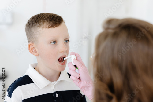 An allergist uses a spray for a patient to treat allergies. Allergen-specific immunotherapy photo