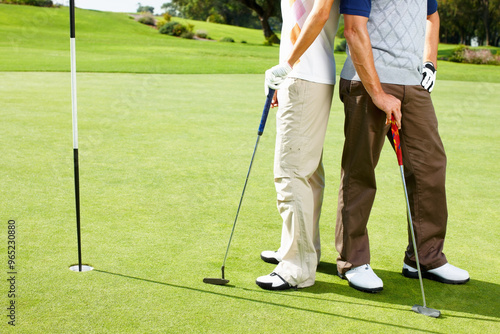 Legs, hole and people on golf course together for teamwork, outdoor fun and fitness competition. Sports, partnership and team on green for bonding, challenge and support in healthy hobby in Portugal