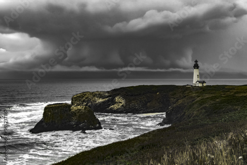 Cyclone and stormic clouds under Yaquina Head Lighthouse and Pacific coast at Newport, Oregon state