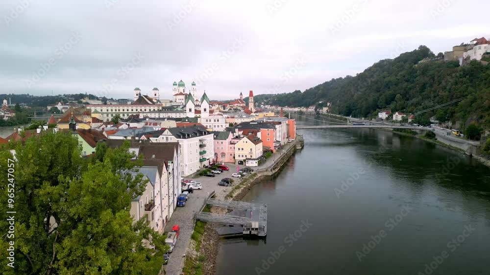 Morning flight over river Danube in Passau, Germany. Drone slide over river with houses, church towers and castle on the hill, Veste Oberhaus Morning flight over river Danube in Passau, Germany. Drone slide over river with houses, church towers and castle on the hill, Veste Oberhaus