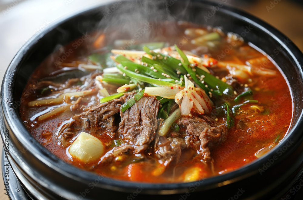 A steaming bowl of spicy Korean yukgaejang beef soup perfect for spice lovers A steaming bowl of spicy Korean yukgaejang beef soup perfect for spice lovers