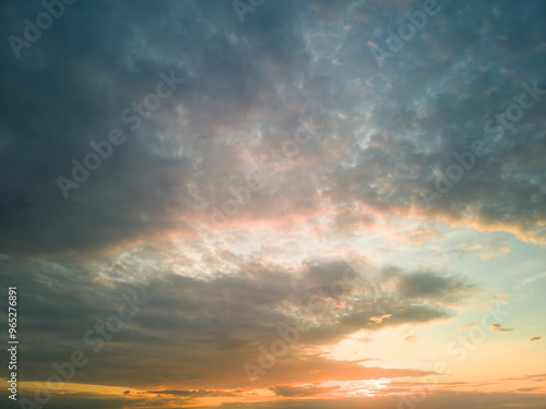 The rays of the sun breaking through the dramatic clouds in the evening or in the morning in the sunset or sunrise sky.