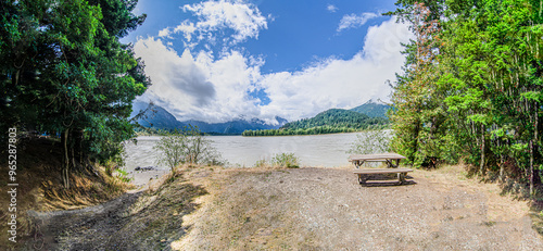 Fraser River with cloud covered green mountains in the background in Hope, BC, Canada