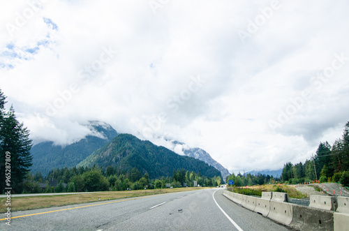 Highway in Hope BC, Canada with cloud covered mountains in the background