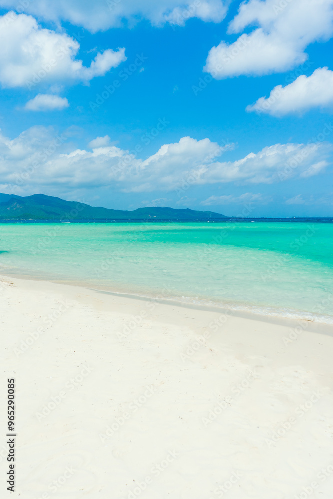 Beautiful sandy beach with white sand and turquoise ocean on Sunny day. Summer vacation and summer holiday concept. Beautiful sandy beach with white sand and turquoise ocean on Sunny day. Summer vacation and summer holiday concept.