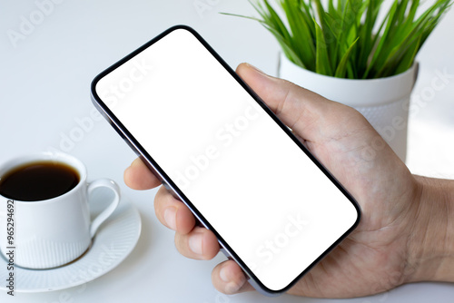 male hand holding phone with isolated screen background white table
