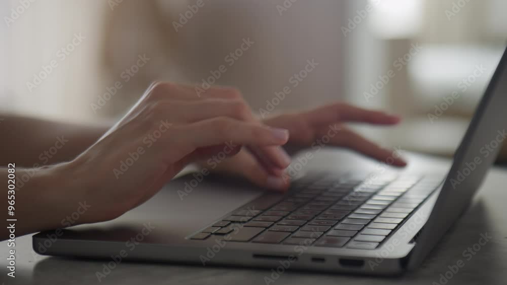 Hands typing on a laptop in a cozy home setting Hands typing on a laptop in a cozy home setting