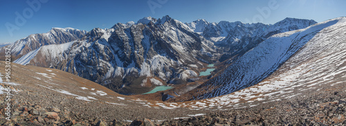 Mountain valley with lakes, view from above, snow and rocky slopes, panoramic view