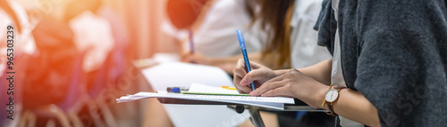 Exam at school with student's taking educational admission test in class, thinking hard, writing answer in university classroom, education and world literacy day concept photo