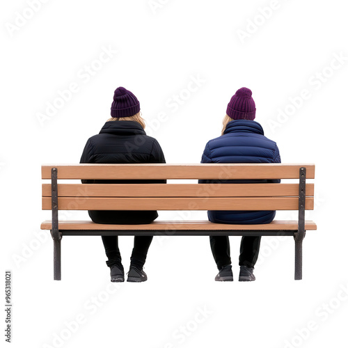 Two individuals sitting on a bench, wearing winter hats, enjoying a peaceful moment in a cozy outdoor setting.