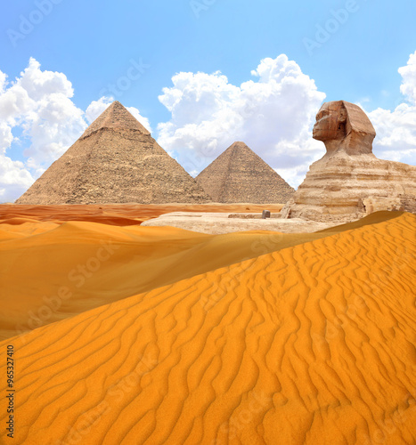 Famous Great Sphinx and pyramids of Chephren and Cheops, Cairo, Egypt. Great Pyramids, ancient statue of Sphinx and beautiful sand dunes, Giza complex (Giza Necropolis)