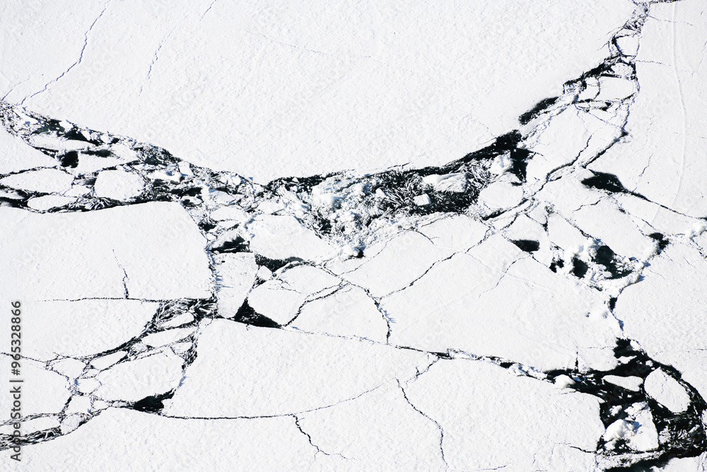 Melting ice on Baikal lake in spring. Abstract nature background. Aerial top down view