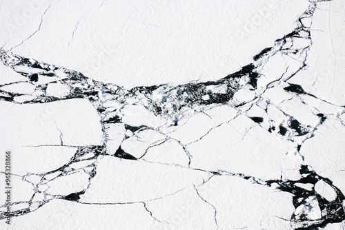 Obraz na płótnie Melting ice on Baikal lake in spring. Abstract nature background. Aerial top down view w salonie