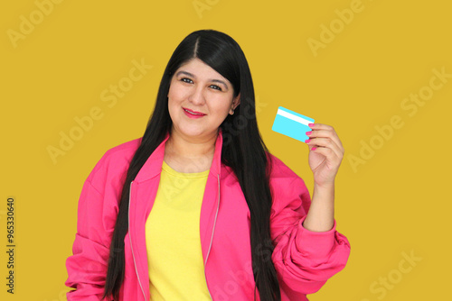 30 year old Latina woman excitedly shows credit card ready to buy with discounts and promotions