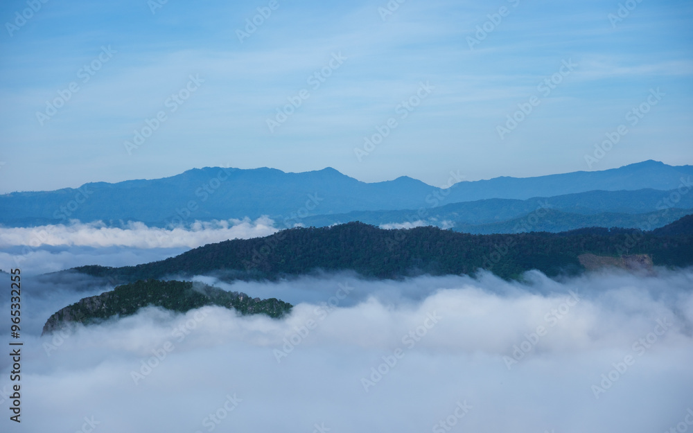 Landscape image of mountains peak with sea of clouds and blue sky Landscape image of mountains peak with sea of clouds and blue sky