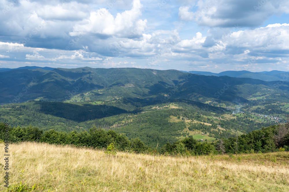 Mountains ranges Carpathian. Hill forest and meadows valley in summer. Blue sky Mountains ranges Carpathian. Hill forest and meadows valley in summer. Blue sky