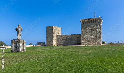 Medieval Castle of Ourem with a statue on the green grass, district of Santarem, Portugal photo