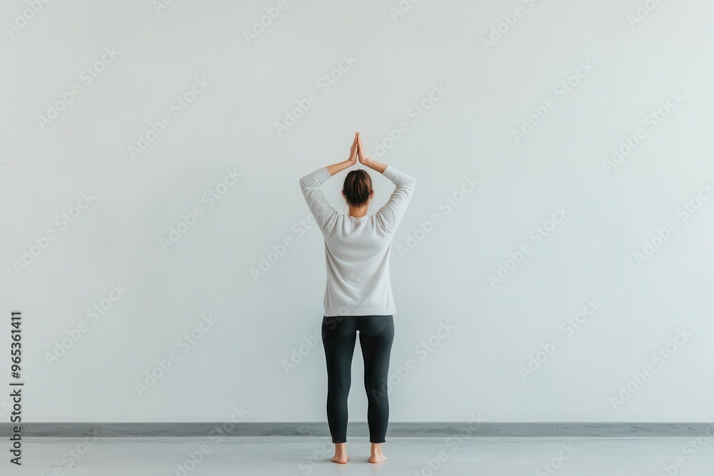 A person standing and performing a forward bend to stretch and relieve tension in the lower back, standing forward bend, back pain relief stretch A person standing and performing a forward bend to stretch and relieve tension in the lower back, standing forward bend, back pain relief stretch