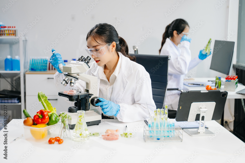 Food scientists in lab coats, testing samples, and analyzing food safety and quality in a laboratory Food scientists in lab coats, testing samples, and analyzing food safety and quality in a laboratory