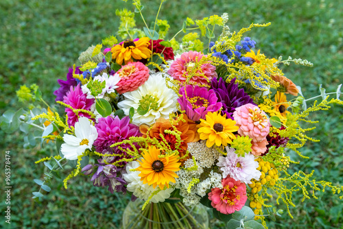 Summer bouquet. Beautiful multi colored fresh flower arrangement. Birthday weddding bouquet made of summer flowers photographed outdoors. photo