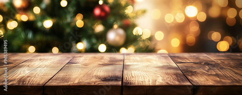 Close up of wooden table and christmas tree in the background, warm home christmas time atmosphere 
