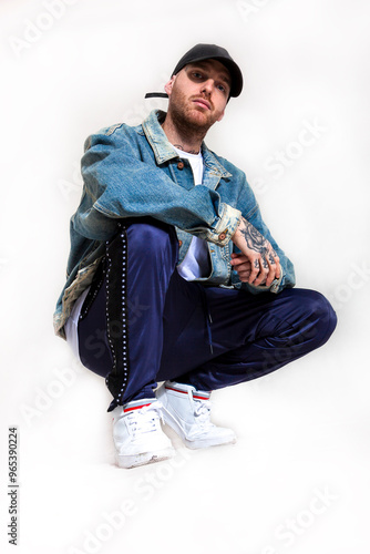 portrait of young active rapper in the studio photo