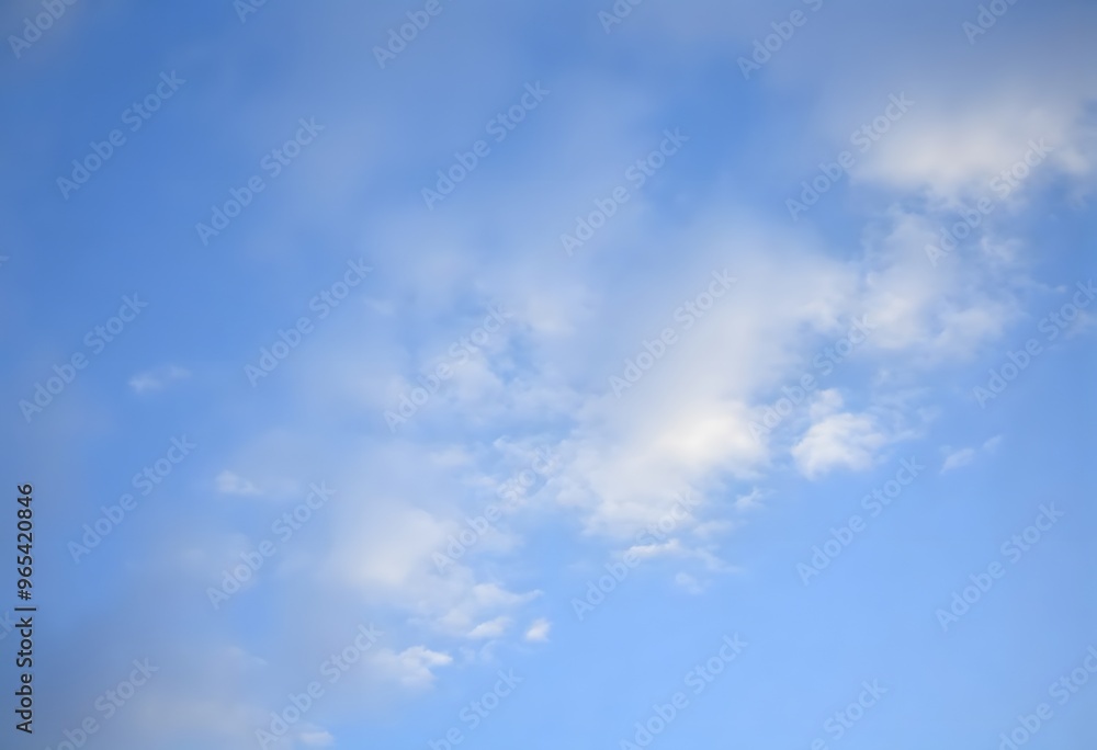 Summer day with a bright blue sky and scattered white clouds Summer day with a bright blue sky and scattered white clouds