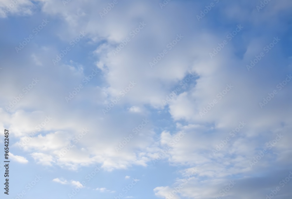 Clear blue sky with fluffy white clouds drifting slowly Clear blue sky with fluffy white clouds drifting slowly