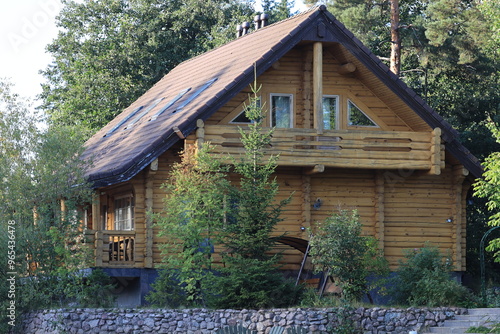 Obraz na plátně Cozy cabin with a black roof and wooden walls.