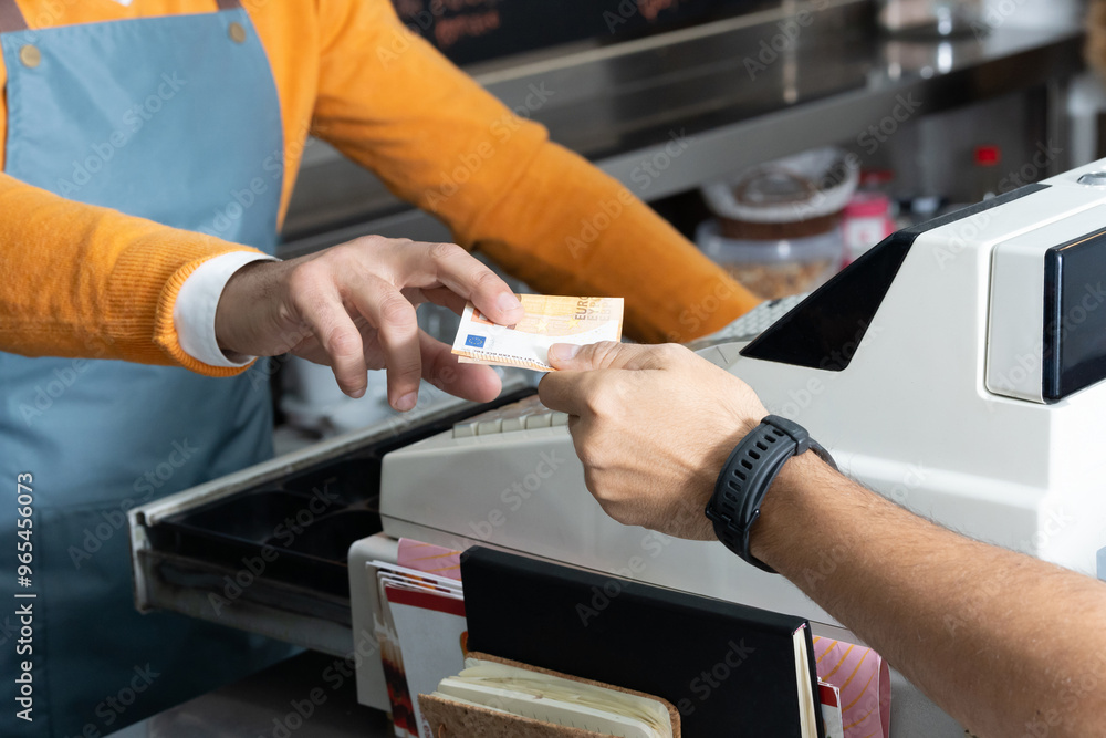Cash transaction at a register, close-up of a hand exchanging euro banknote. Business Cash transaction at a register, close-up of a hand exchanging euro banknote. Business