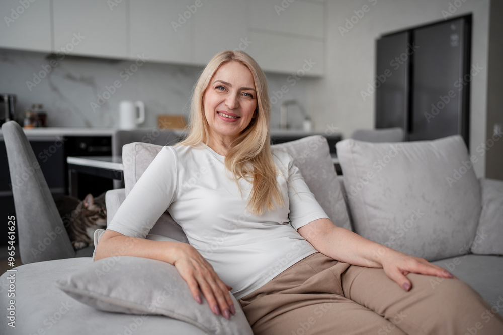 A woman is peacefully lounging on a couch in a contemporary home with simple and clean design A woman is peacefully lounging on a couch in a contemporary home with simple and clean design