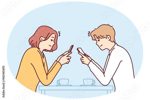 Couple with phones sits in cafe, addiction to social networks and internet chatting, not paying attention to interlocutor. Concept of social problems associated with digital addiction to gadgets