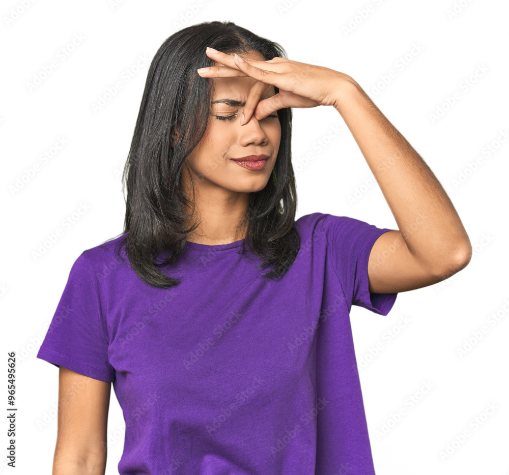 Young Latina posing in studio having a head ache, touching front of the face. Young Latina posing in studio having a head ache, touching front of the face.