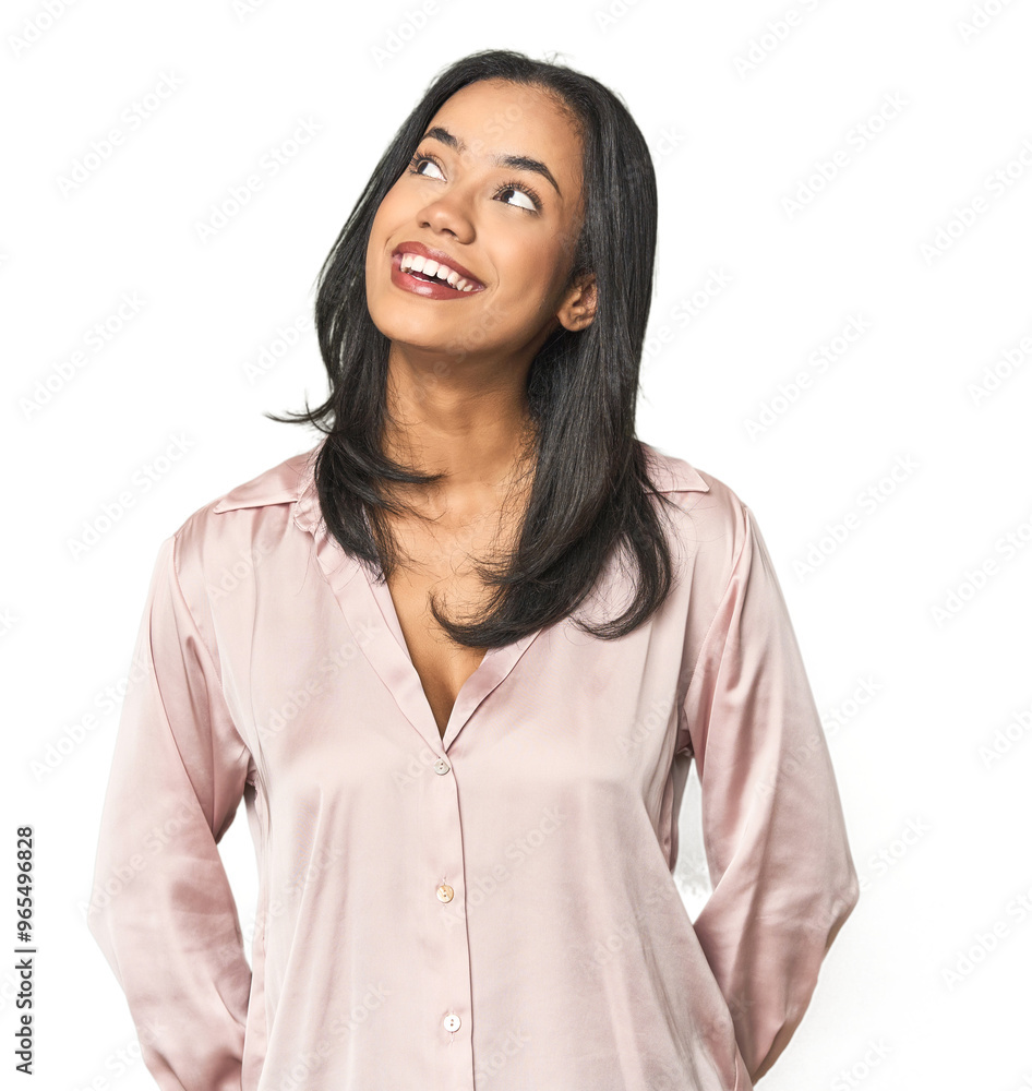 Simple portrait of a young Latina relaxed and happy laughing, neck stretched showing teeth.