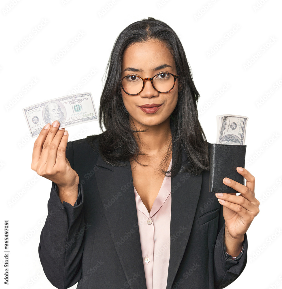 Young Latina businesswoman holding dollars in studio Young Latina businesswoman holding dollars in studio