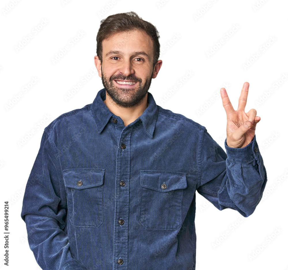 Studio portrait of young Hispanic male joyful and carefree showing a peace symbol with fingers.
