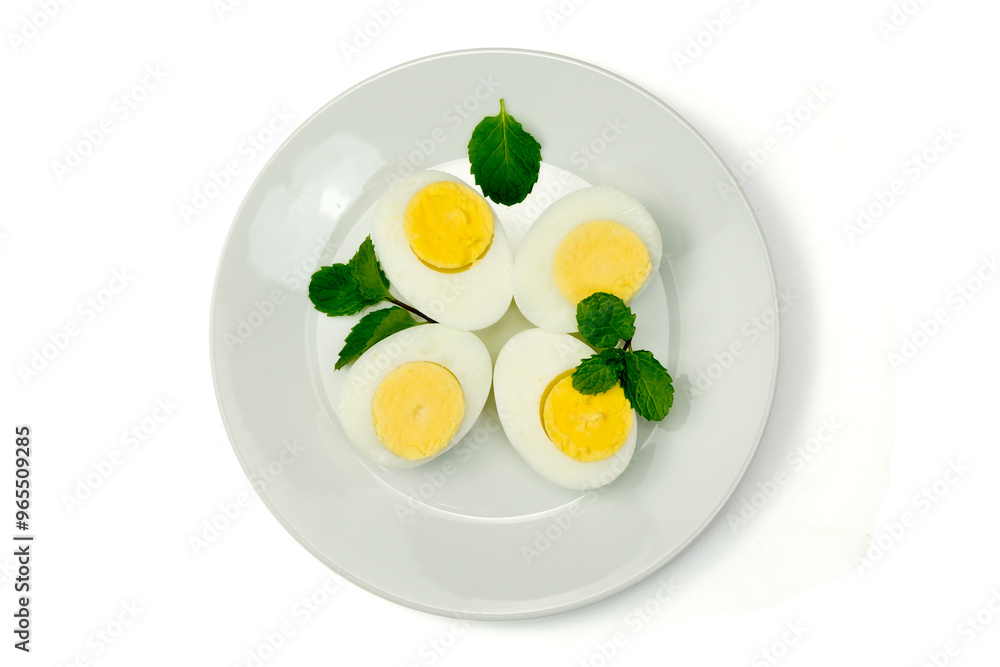 Four pieces of half sliced hard boiled eggs with mint leaves in white plate on white background top view, clipping path, stack. Preparing to cook. Four pieces of half sliced hard boiled eggs with mint leaves in white plate on white background top view, clipping path, stack. Preparing to cook.